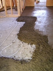 In floor heating tubes covered by 3 inches of cob sub floor